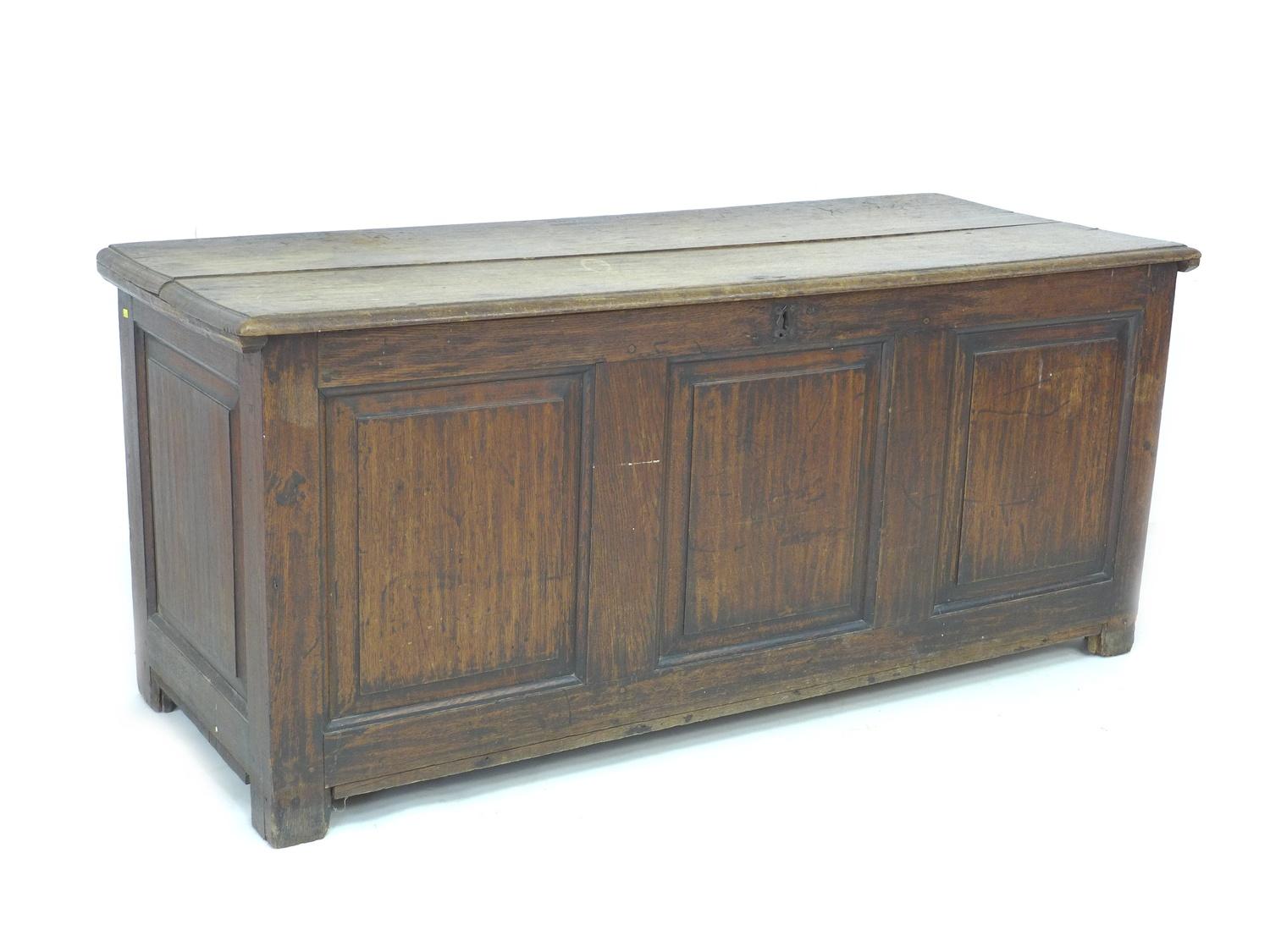 A large 18th century oak chest, two plank lift top, three panel front, stile feet, 155 by 63 by 67.