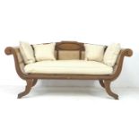 A modern tropical wood bergere settee, with carved frame and scroll arms, caned seat, sides and
