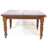A late Victorian oak extending dining table, with two additional leaves, 29cm and 30cm, carved