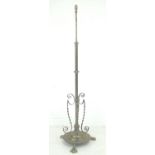 A late Victorian brass telescopic standard lamp, with circular floral embossed foot and three