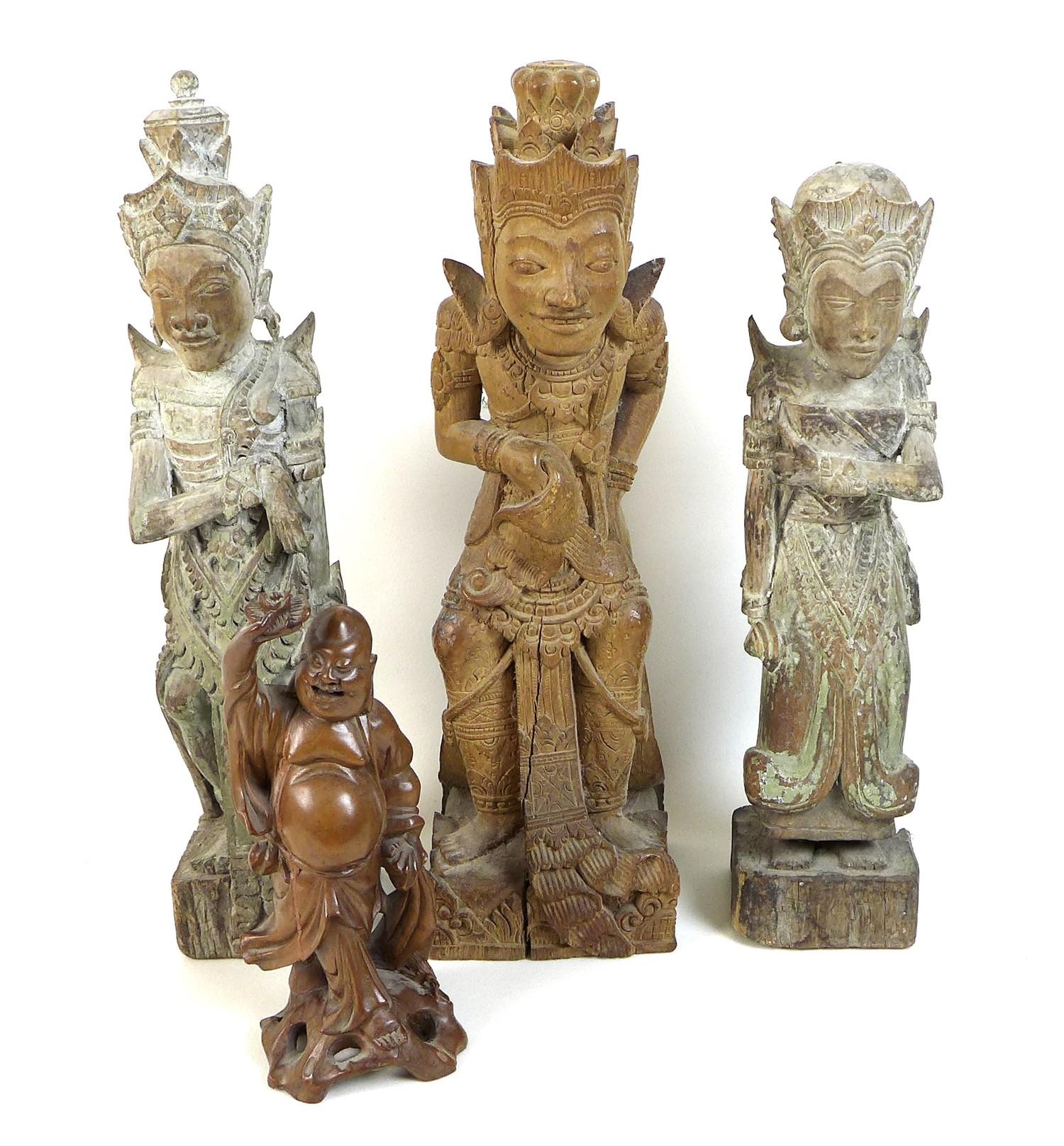 A group of four wooden carvings, comprising a Chinese carving of a man holding a flower aloft, 20cm,