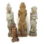A group of four wooden carvings, comprising a Chinese carving of a man holding a flower aloft, 20cm,