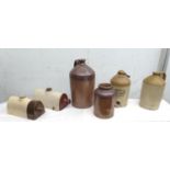 A group of stoneware jugs, including an S. Wright & Co brewery jug, and two hot water bottles,