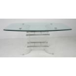 A modern design dining table, shaped rectangular clear glass surface with bevelled edge raised on