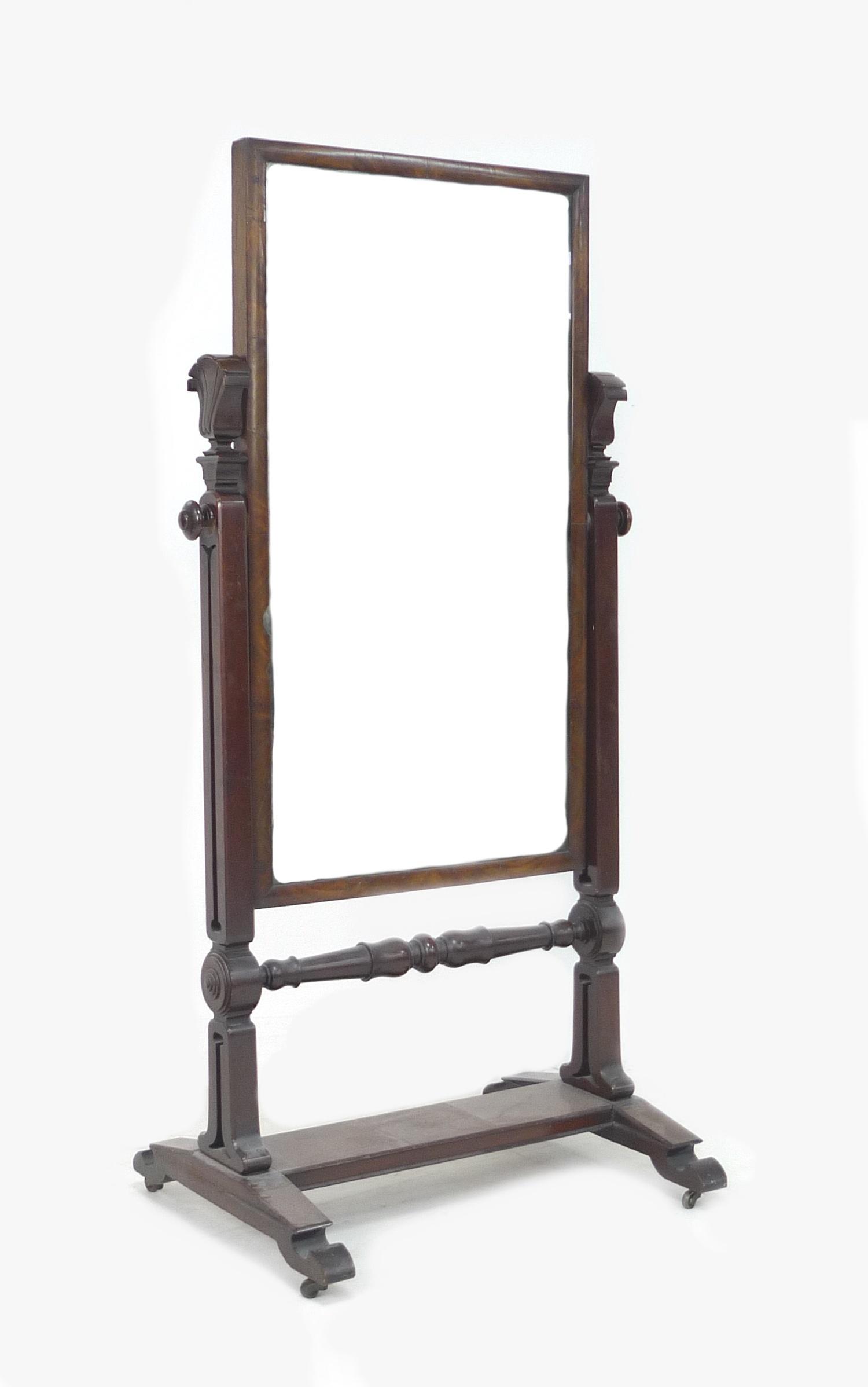 A William IV mahogany cheval mirror, rectangular plate, foliate carved supports, on a rectangular