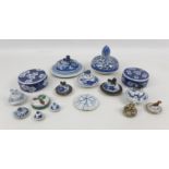 A collection of fourteen 19th century Chinese and Japanese porcelain lids, including mostly