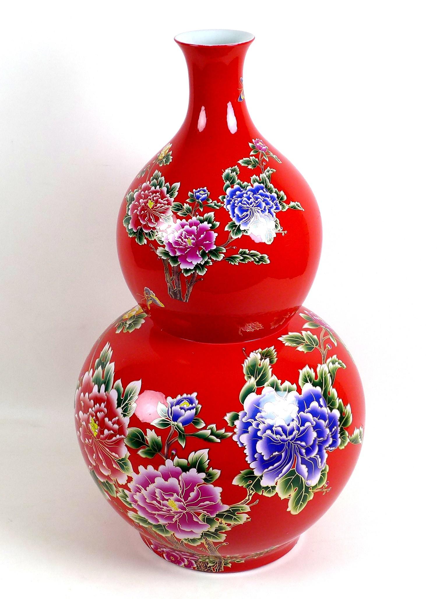 A large modern Chinese porcelain double gourd vase, with printed floral decoration against a red