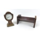An early 20th century tulip form mantel clock, with Roman numeral dial, walnut veneered case with