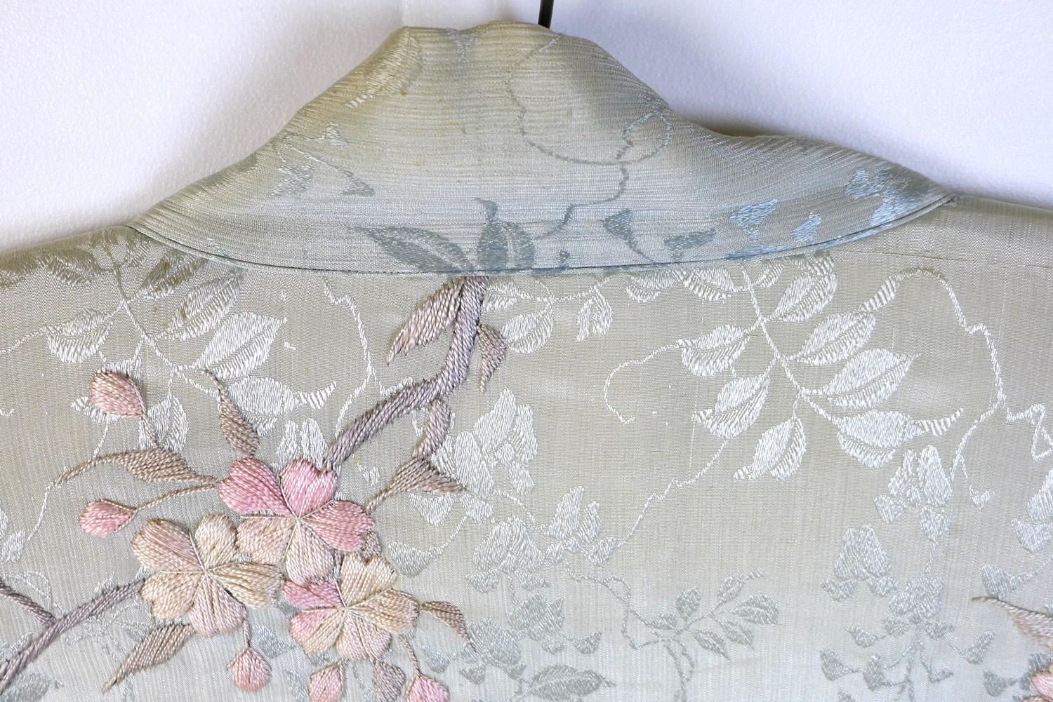 An early 20th century Japanese haori padded jacket, embroidered in silk with white and pink flowered - Image 12 of 17