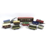 A collection of Hornby 0 gauge rolling stock, wagons, and other accessories, including a crane