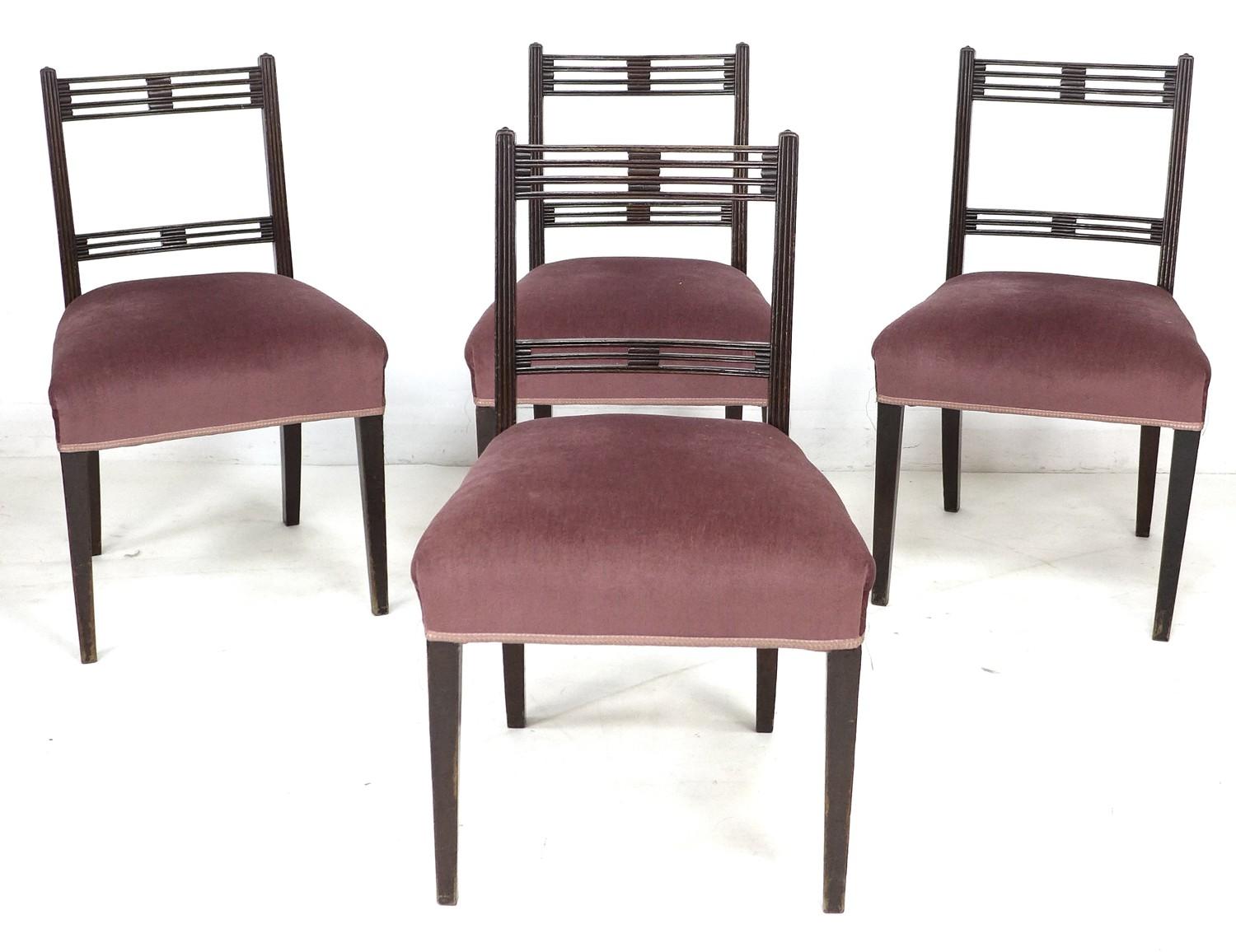 A set of four Regency mahogany dining chairs, each with pierced decoration to top rails, upholstered