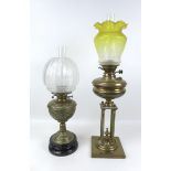 Two Victorian brass paraffin lamps, one with brass reservoir and unusual base with four column on