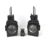 A pair of black British Rail lamps, both in black, with magnified lenses, each 20 by 24 by 45cm