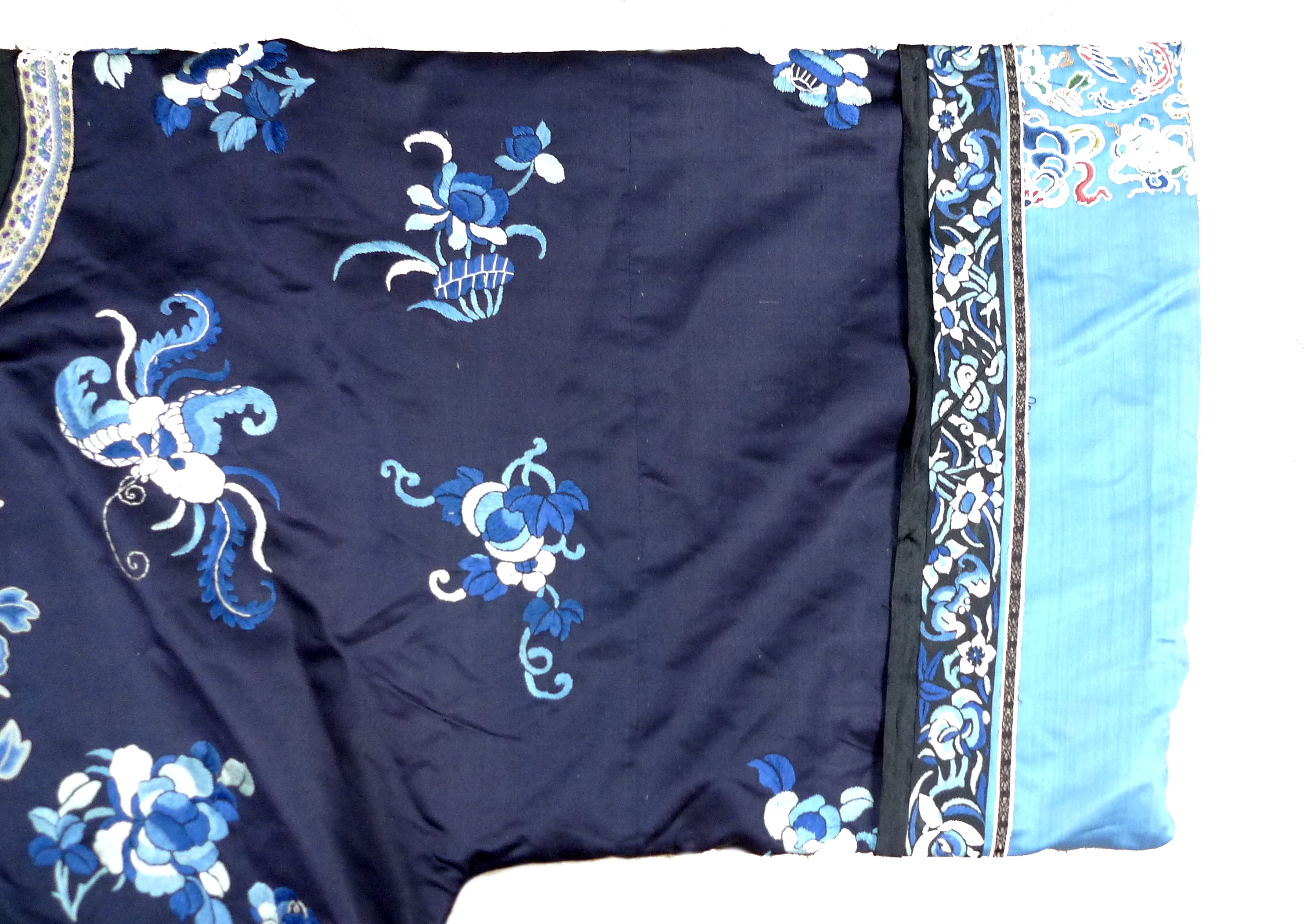 An early 20th century silk Chinese robe, with navy blue ground and intricately embroidered with - Image 30 of 34