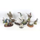 A collection of eight wildlife figurines, comprising a Border Fine Arts long eared owl, 20 by 19