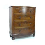 A Victorian bow fronted figured mahogany chest of drawers, with two over three drawers, raised