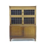 A 1930's glazed mahogany bookcase, by Minty Limited, Library Specialists, Oxford, with two leaded