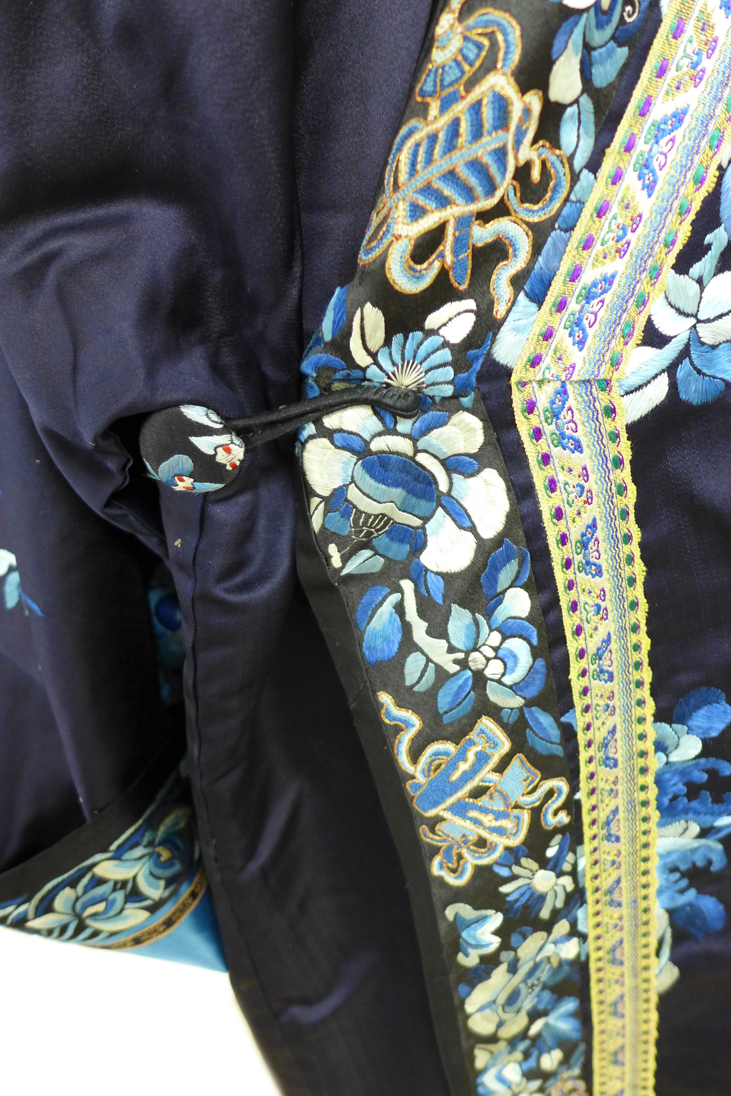 An early 20th century silk Chinese robe, with navy blue ground and intricately embroidered with - Image 13 of 34