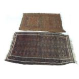 Two hand knotted woolen rugs, one with a dark blue ground and an orange geometric design with