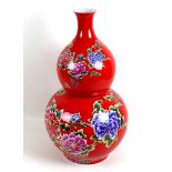 A large modern Chinese porcelain double gourd vase, with printed floral decoration against a red