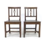 Two George III oak chairs, with pierced slats, solid seats, and square fore legs and rear