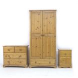 A modern pine bedroom suite, comprising a two door wardrobe, 86 by 52 by 180, a chest of two over