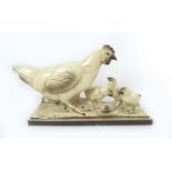 A French mid to late 20th century ceramic figural group, modelled as a hen with chicks and a