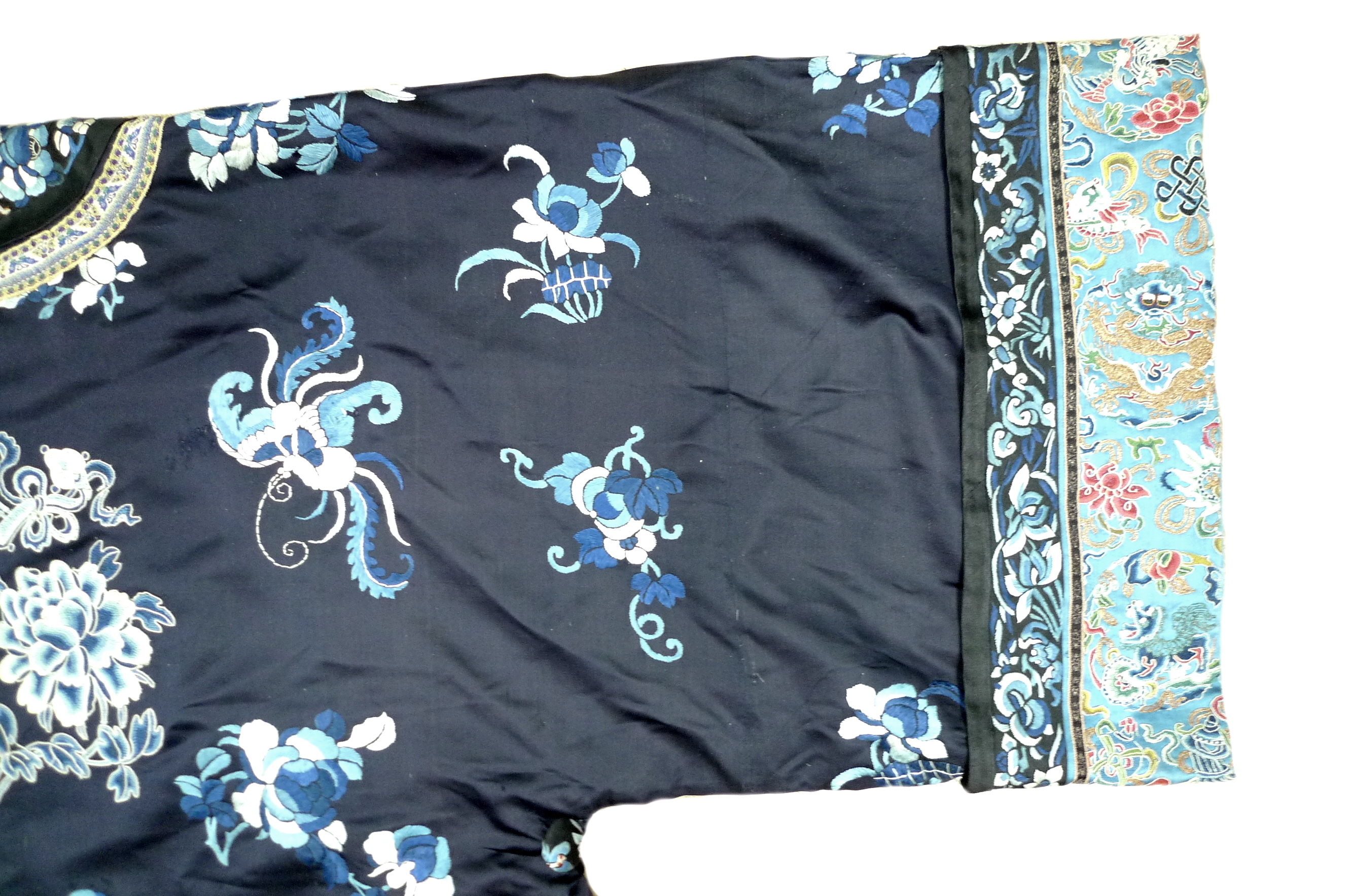 An early 20th century silk Chinese robe, with navy blue ground and intricately embroidered with - Image 20 of 34