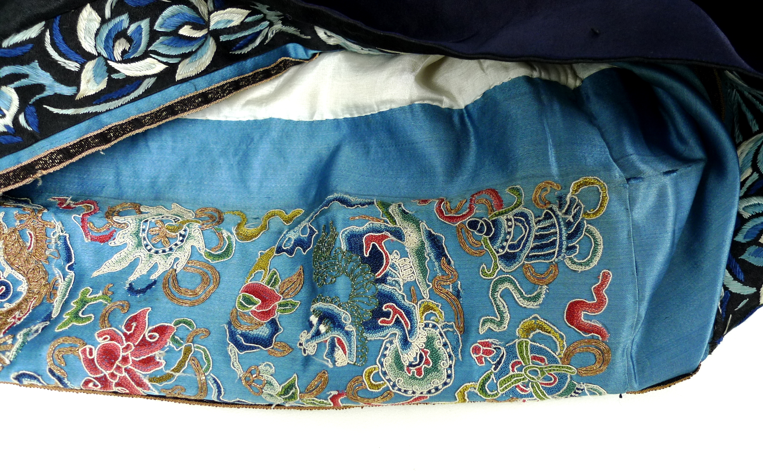 An early 20th century silk Chinese robe, with navy blue ground and intricately embroidered with - Image 19 of 34