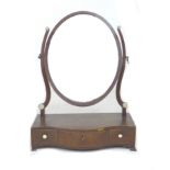 A 19th century mahogany toilet mirror, with oval shaped plate, below three serpentine fronted