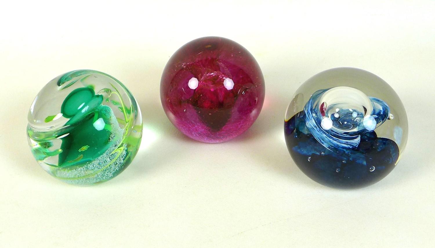 A group of three Caithness paperweights, comprising Spring Festival, an unnamed red spiral, and an