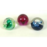 A group of three Caithness paperweights, comprising Spring Festival, an unnamed red spiral, and an