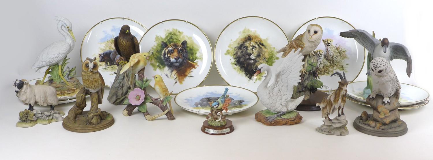 A group of twenty various wildlife figurines, including a Border Fine Arts style Hawk, signed Tom