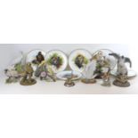 A group of twenty various wildlife figurines, including a Border Fine Arts style Hawk, signed Tom