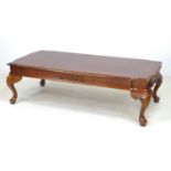 A modern walnut veneered coffee table, with crossbanded decoration, carved frieze and cabriole legs,