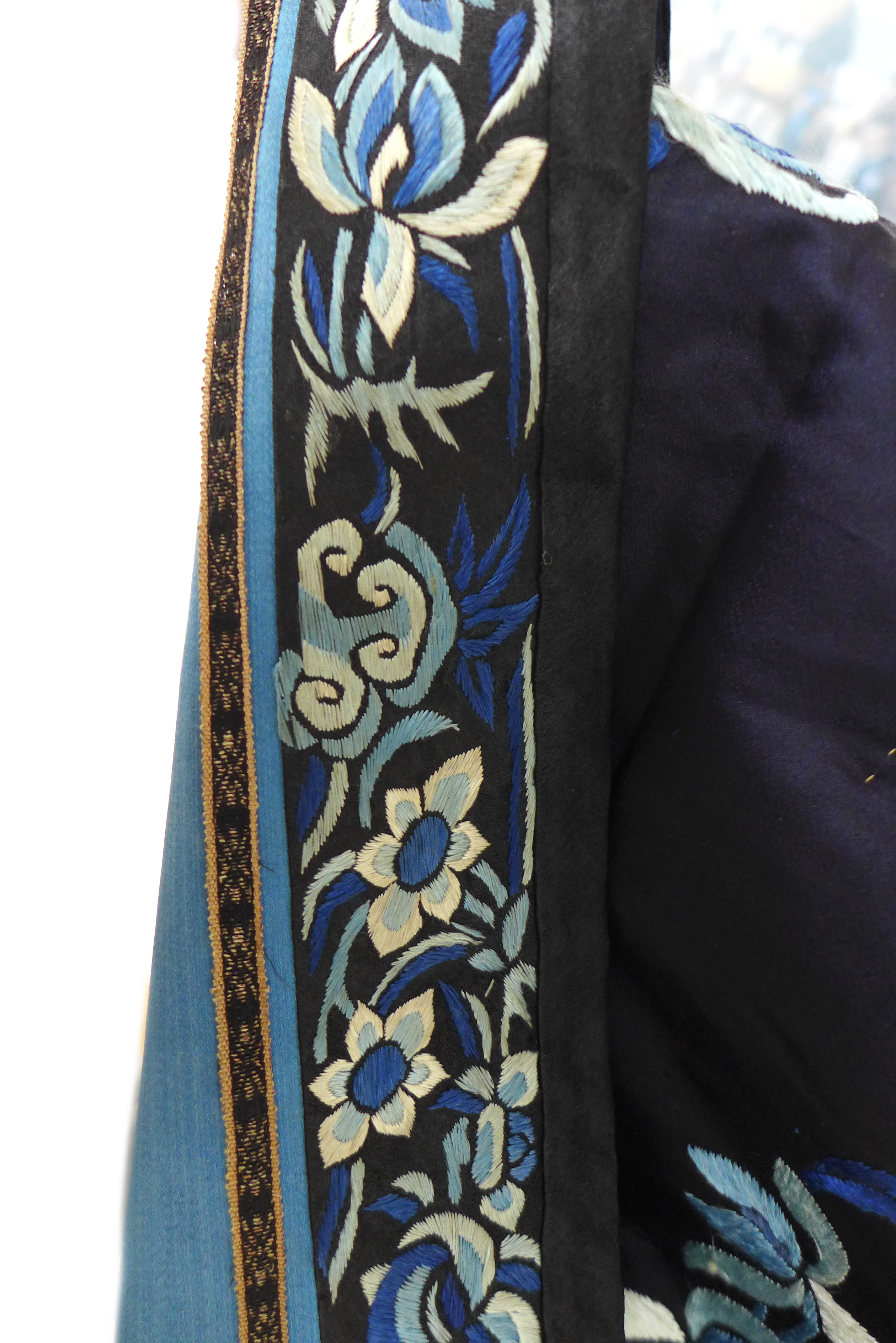 An early 20th century silk Chinese robe, with navy blue ground and intricately embroidered with - Image 12 of 34