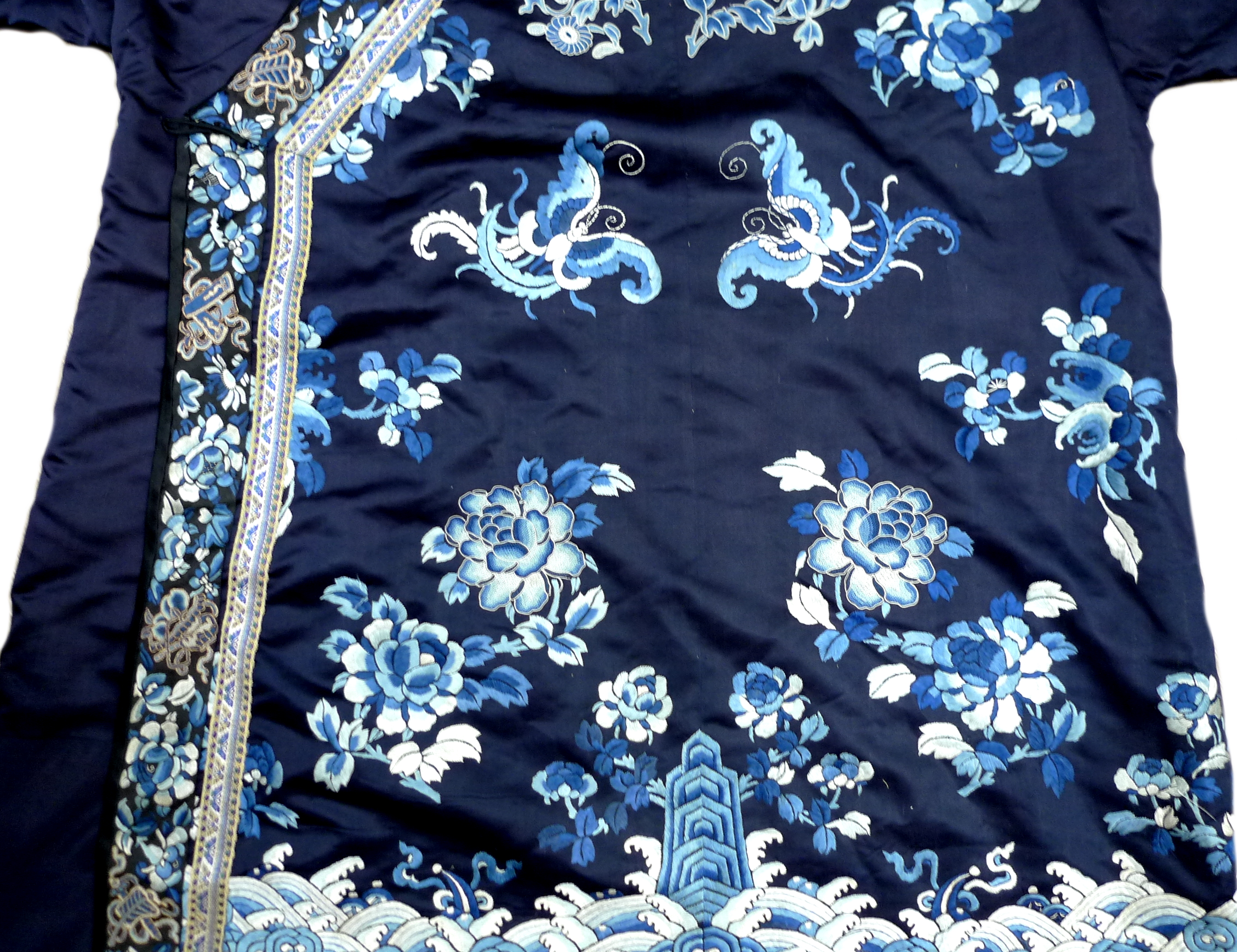 An early 20th century silk Chinese robe, with navy blue ground and intricately embroidered with - Image 7 of 34