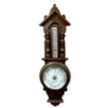 An oak cased aneroid barometer and thermometer, by Harris & Son, Spalding, circa 1940, the case