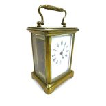 A 19th century brass carriage clock, five glass case, with key, in leather travelling case.