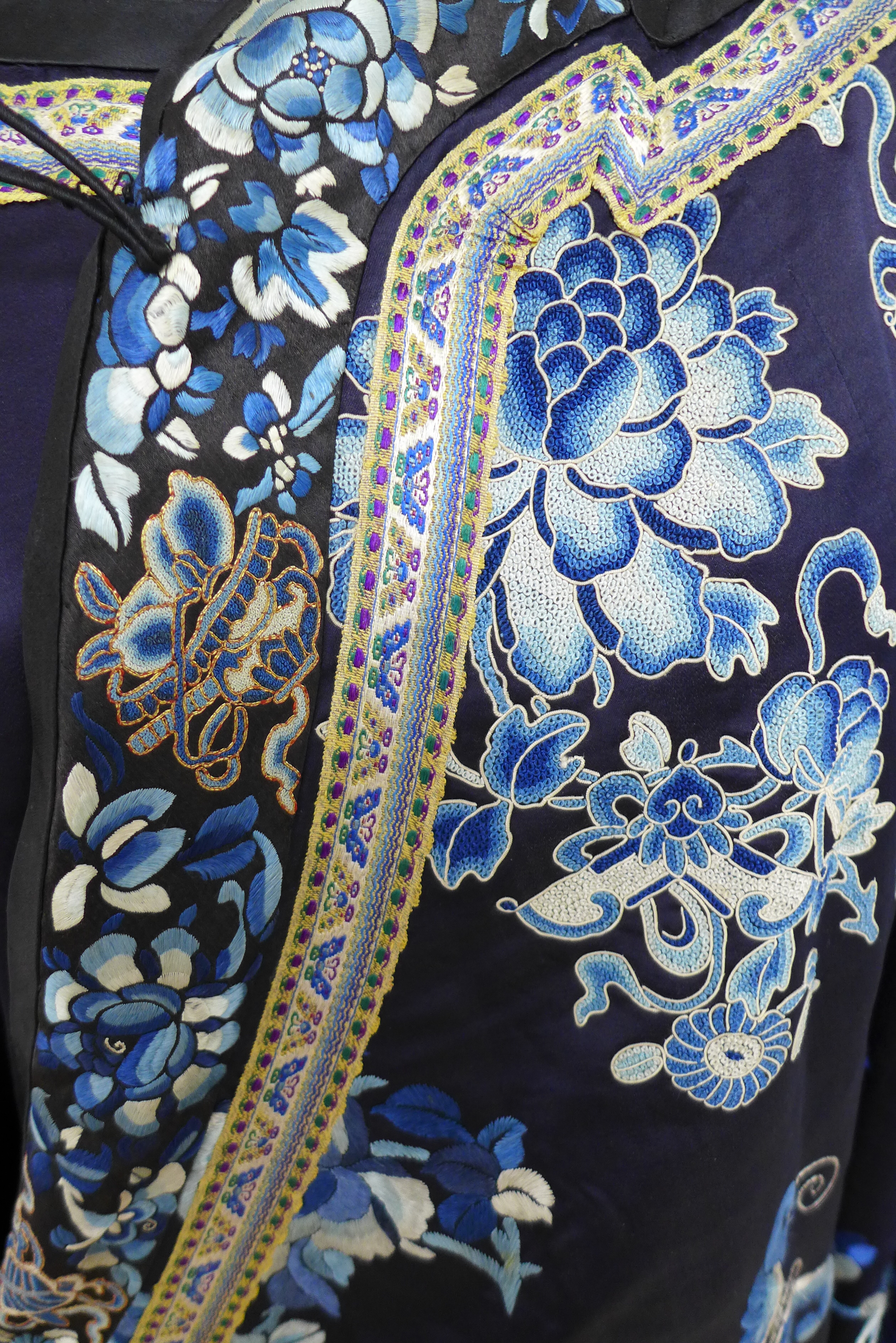 An early 20th century silk Chinese robe, with navy blue ground and intricately embroidered with - Image 11 of 34