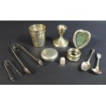 A small group of silver items, comprising a dwarf candlestick, 7 by 7.5cm high, a heart shaped easel