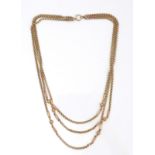 A 9ct gold three strand necklace, each rolo link strand with two decorative orbs, hoop and clasp