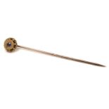 A Victorian yellow gold stick pin, set with a 0.1ct pale blue sapphire, with threaded screw allowing