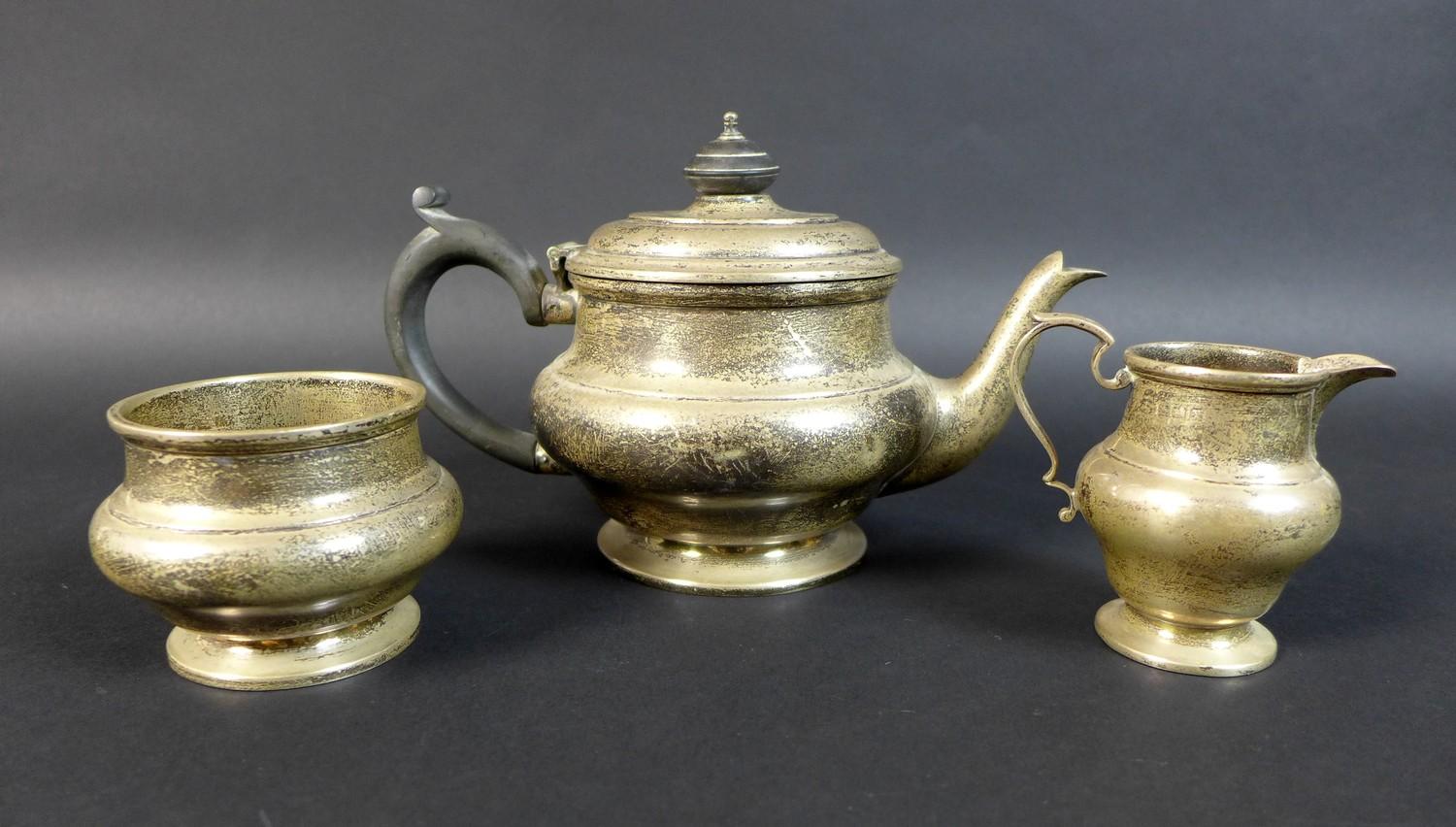 A George V silver bachelor's tea set, of compressed bun form on circular foot, comprising a teapot