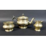 A George V silver bachelor's tea set, of compressed bun form on circular foot, comprising a teapot