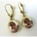A pair of 14ct gold tourmaline earrings, the oval cut stone 5.5 by 7.5cm, with white and yellow gold