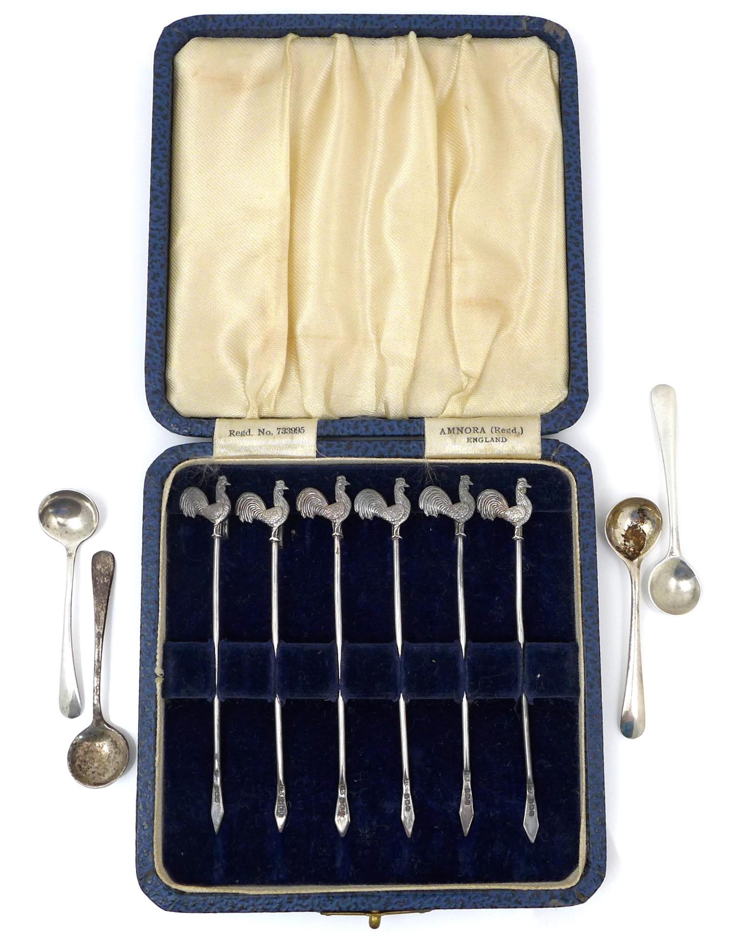 A set of six George V silver cocktail sticks, by Amnora, England, the terminals in the form of
