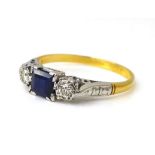An 18ct gold, platinum, sapphire and diamond ring, the central square cut sapphire, 4.5 by 4.5 by