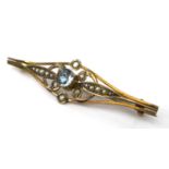 An Edwardian 9ct gold, aquamarine, and seed pearl bar brooch, the central brilliant cut stone, 4.5