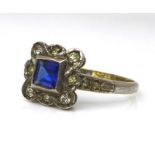 An Art Deco style 9ct gold, silver and paste ring, the square setting with central emerald cut